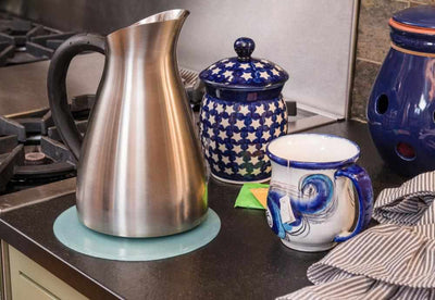 silicone trivet being used under hot tea pot
