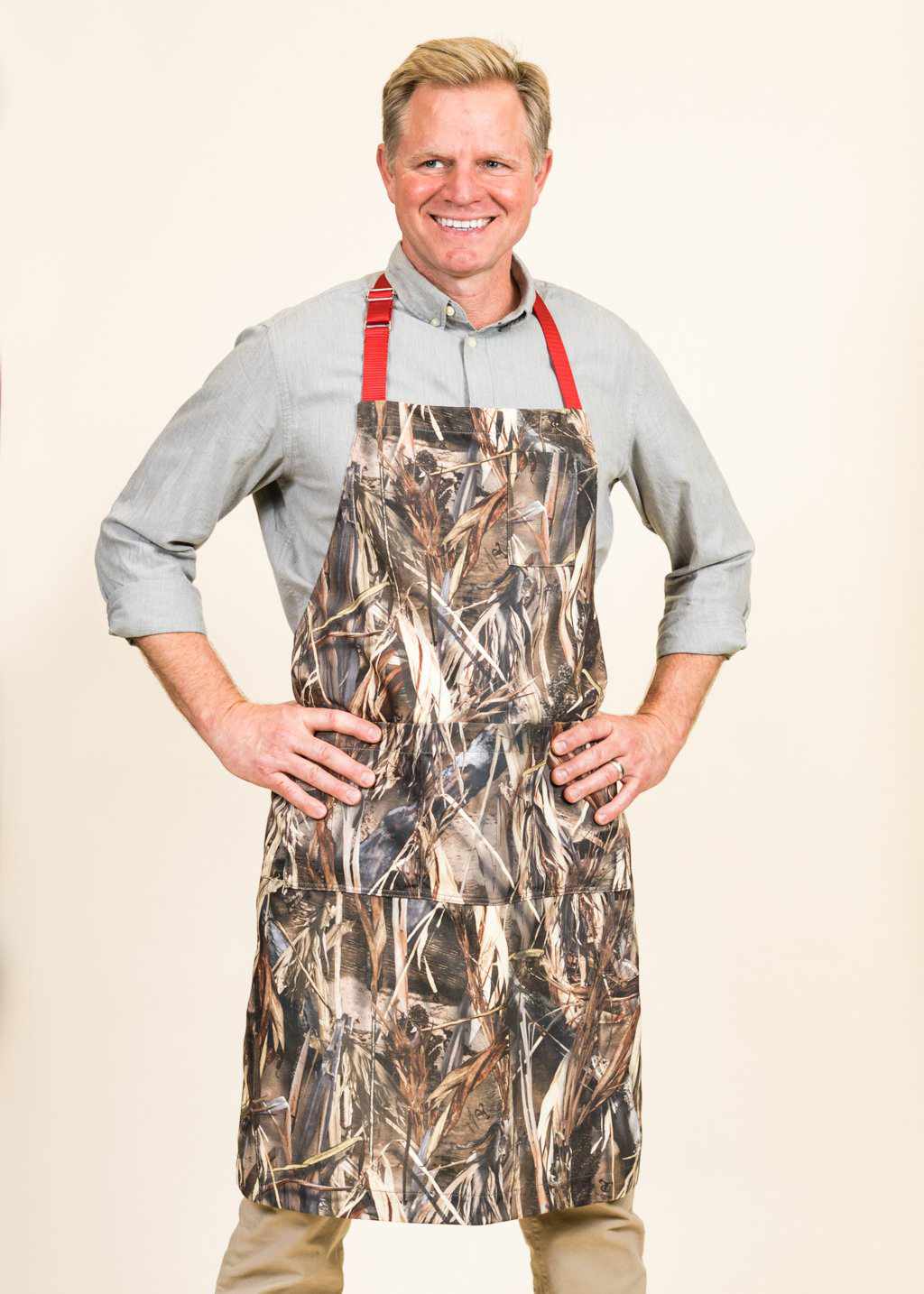Man about to grill with his camo apron from aprons by jem